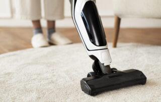 This image shows a vacuum machine being used to clean a carpet.